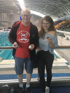 John Collis proudly displaying his medals with daughter Georgie. 