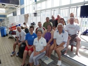 This image shows Molonglo Water Dragons Team (left to right) Front row: Les Worthington, Trinity King , and Margaret Larkin; 2nd row: Geoff Llewellyn, Tanya Colyer, and Gary Stutsel; 3rd row: Mark Carroll, Mary Liz Partridge, John Collis; Top row: Gavin Atherton, Tim Booth, Ed Auzins. Missing Ross Burden and Paul Maggs.