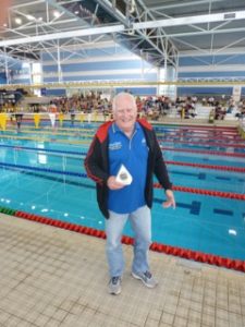 This image shows Water Dragons President John Collis with the trophy for first place in the 3rd Division at the NSW Short Course Championships